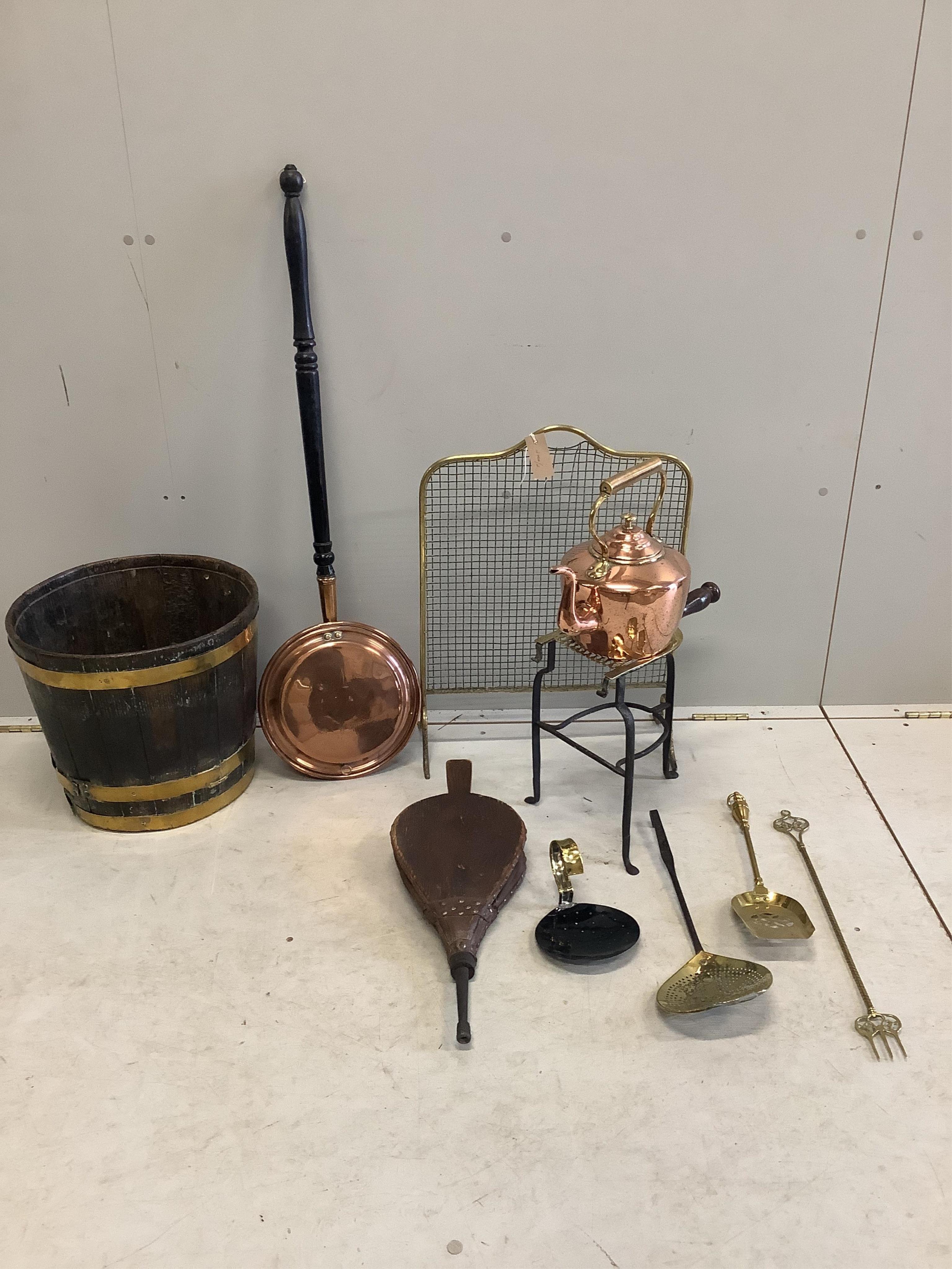 A brass bound staved oak coal bucket, a Victorian copper and brass kettle, Victorian brass mounted wrought iron trivet and sundry metalware. Condition - fair to good